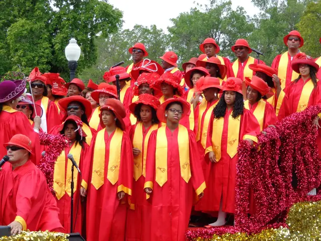 Gospel choir in bright red robes with yellow stoles singing outdoors
