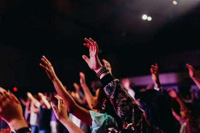 Close view of raised hands during a worship service